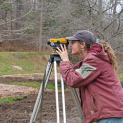 student surveying land